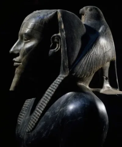 Statue with a bird perched behind it